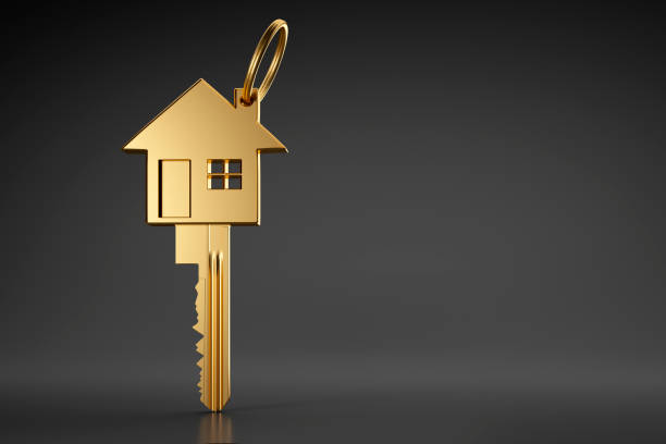 Golden House Shaped Key On Dark Background